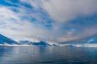 Snow covered mountains rise near the shore of Mushamna Bay Spitsbergen Island-Svalbard-Norway Art Print